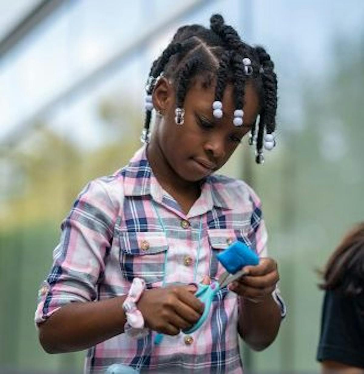 a kid cutting a piece of clay